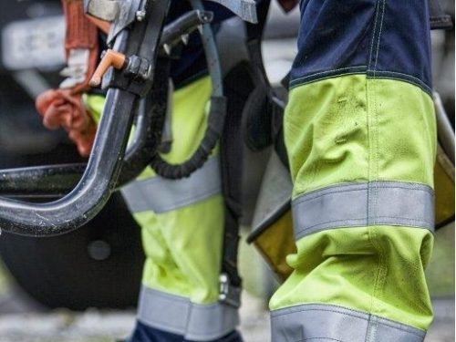 person working in workwear pants with reflective tapes on the pant